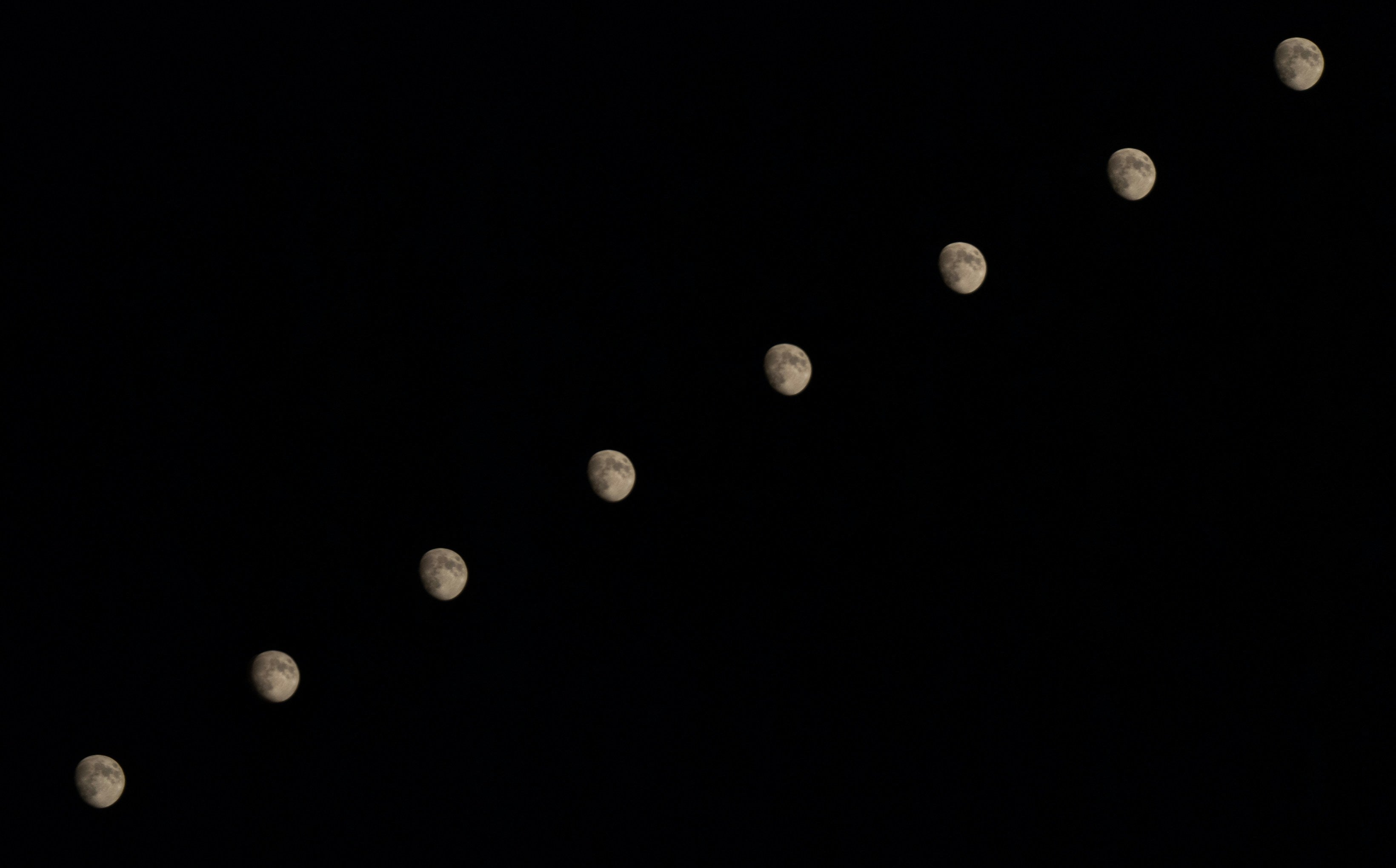 Background image of 8 moons in a right diagonal line